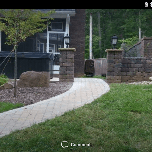 Paver walkway leading from the driveway to the rea