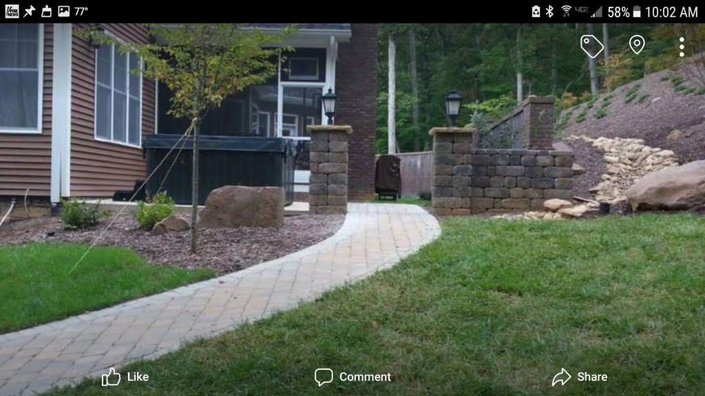 Paver walkway leading from the driveway to the rea