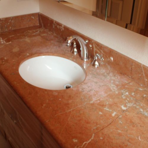 Marble vanity with etching on surface.