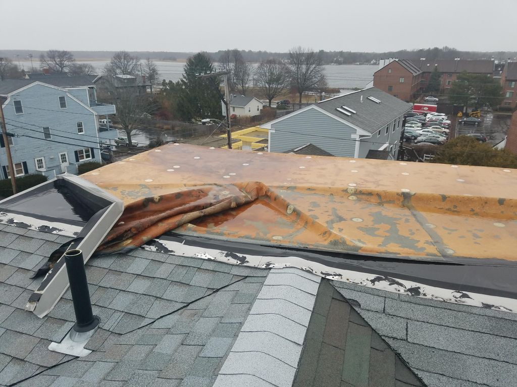 Rubber roof peeled back from wind and poor install