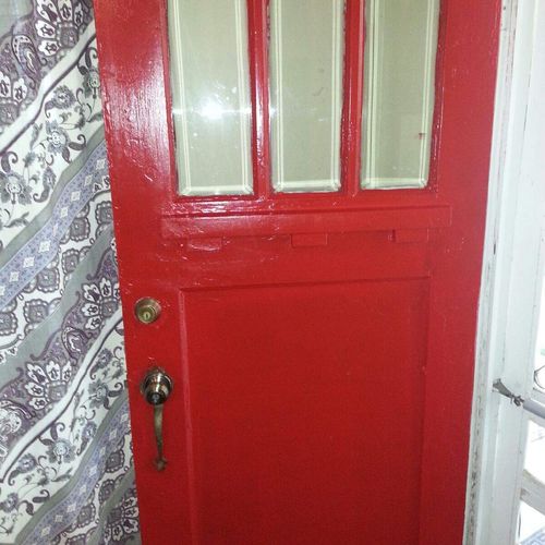 Front door painted cherry red. Stage 1 first coat.