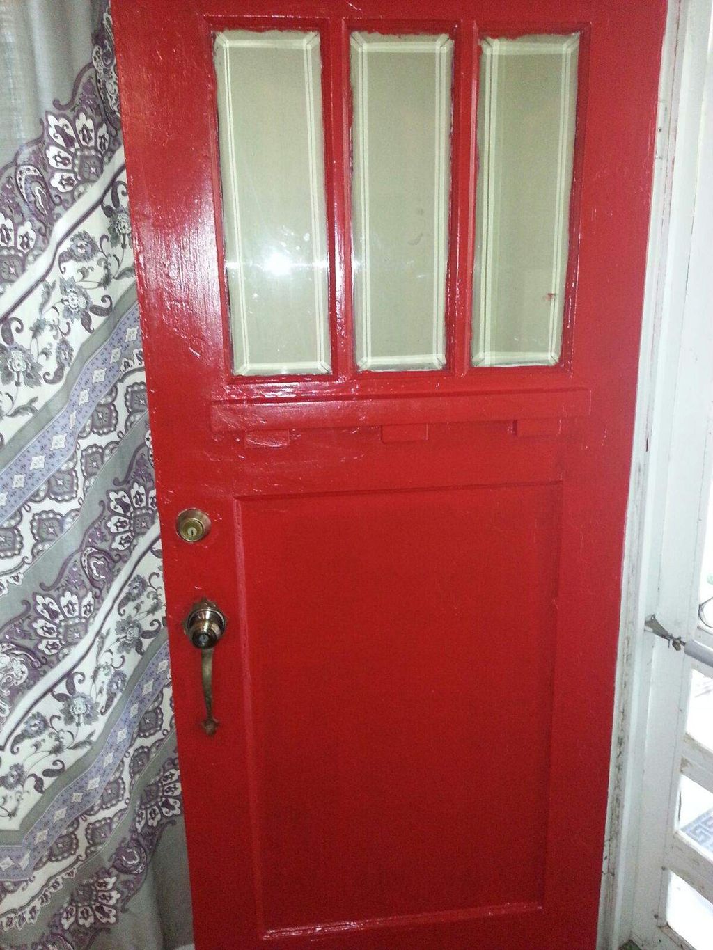Front door painted cherry red. Stage 1 first coat.