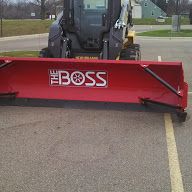 Skid steer with Pusher waiting for snow