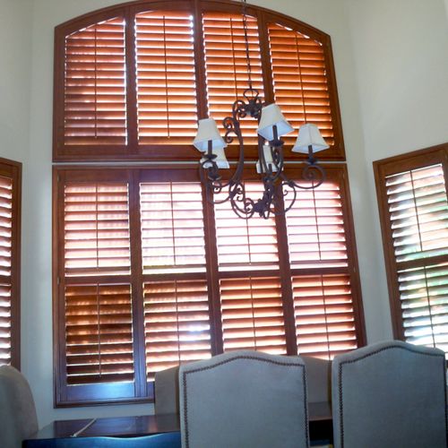 Stained wood shutters with arch top