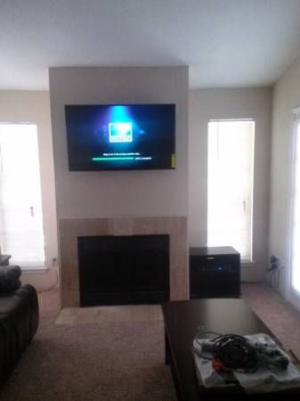 Tv mount on the fire place with the cable coming o