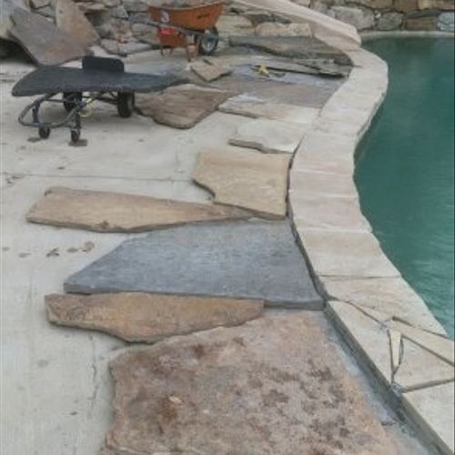 Installation of natural rock on pool deck.