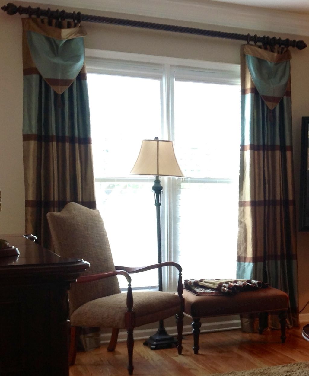 Pleated panel with attached swag on a pole with ri