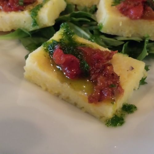 Creamy polenta squares with sun dried tomatoes, ro