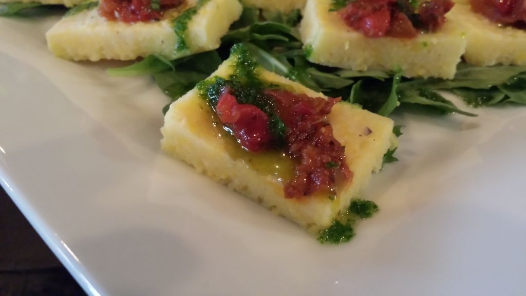 Creamy polenta squares with sun dried tomatoes, ro