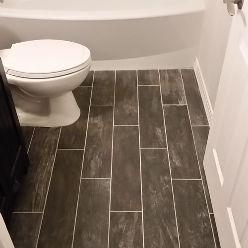 installed new bathtub and tile flooring
