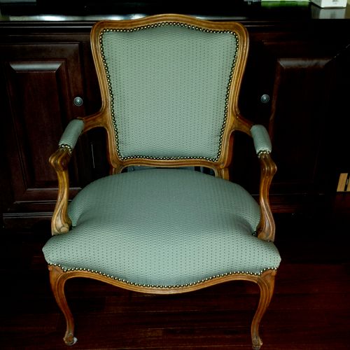 Re-upholstered chair with nailhead trim and rebuil