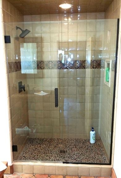 Inline heavy glass shower door and a panel.