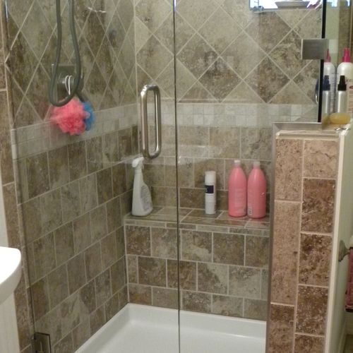 Tile Shower with frameless glass surround.