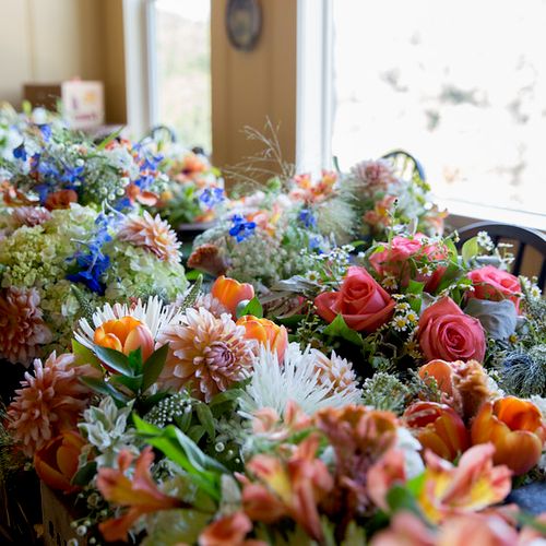 Field of flower arrangements before going on table