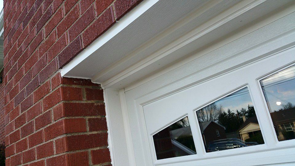 AFTER: Covered with Vinyl Boards and caulked openi