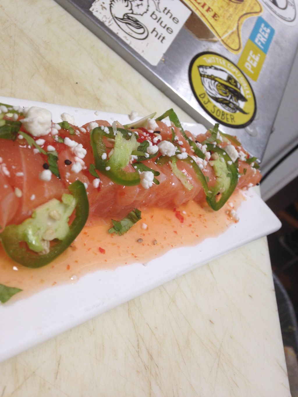 sweet chili salmon sashimi, top with cilantro, goa