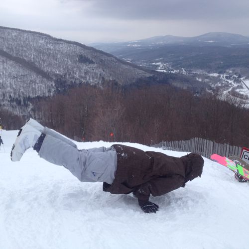 snowboarding yoga break on top of hunter mtn in up