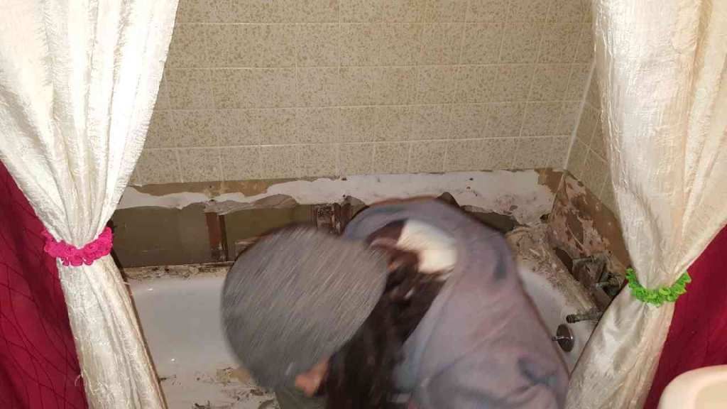 Repairing water leak and damage behind tile