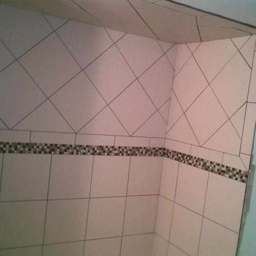 tiled shower and ceiling