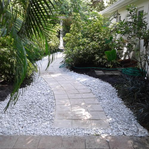 Weedless stone paver walkway bordered with decorat