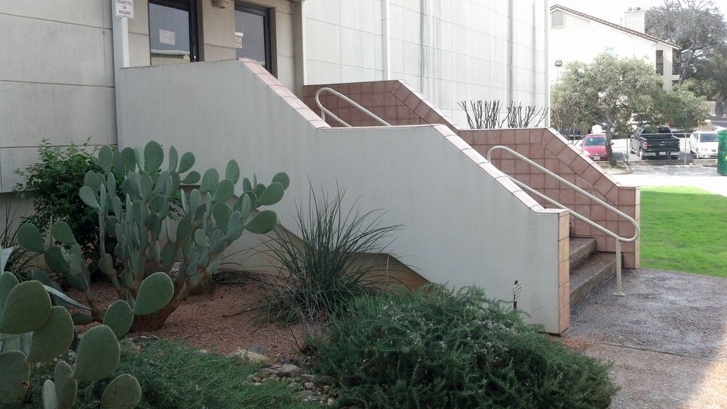 Clean EIFS (Drivit) stair wall.