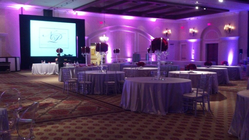 Uplights and video screen for a wedding.