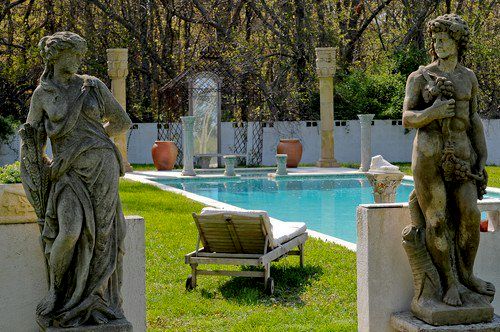 An exotic pool and jacuzzi graced with roses and a