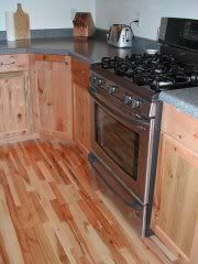 Installed wood flooring with cabinets, and applian