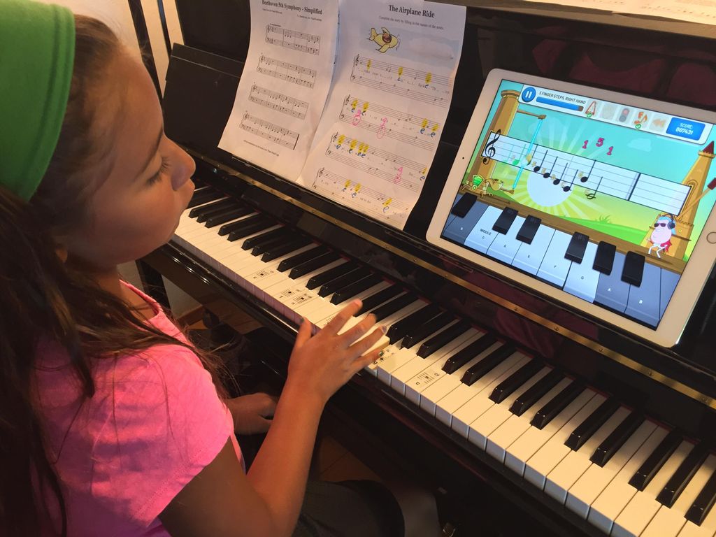 Amy playing with piano maestro app with the iPad P