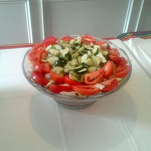 green salad with tomato, mixed greens, cucumbers, 