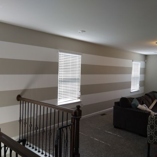 white stripes, painted onto gray wall 