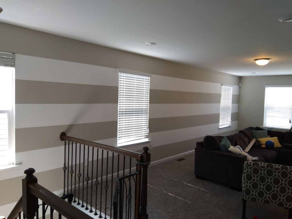 white stripes, painted onto gray wall 