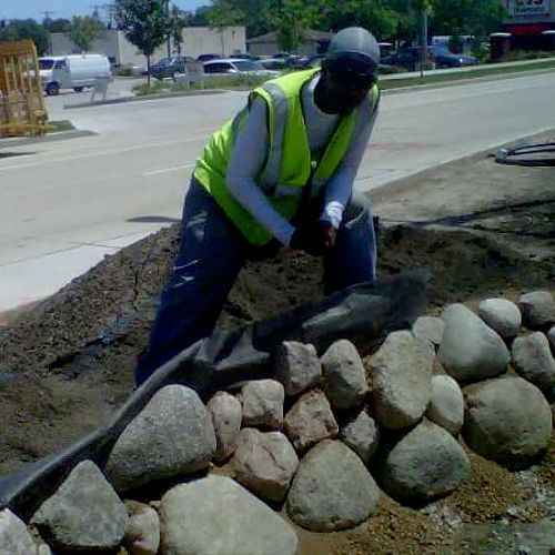 Installing boulder wall.