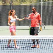 Helping one of my students with her forehand.
