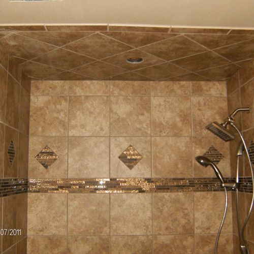 custom shower and hidden soap shelf in stub wall