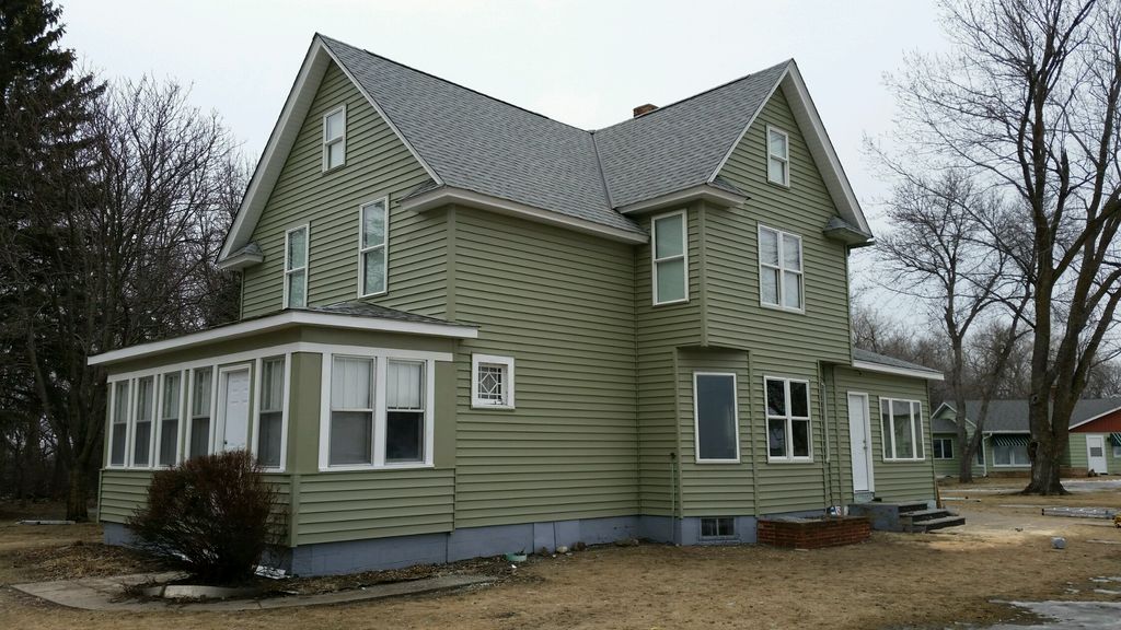 100 year old farmhouse with new siding windows sof