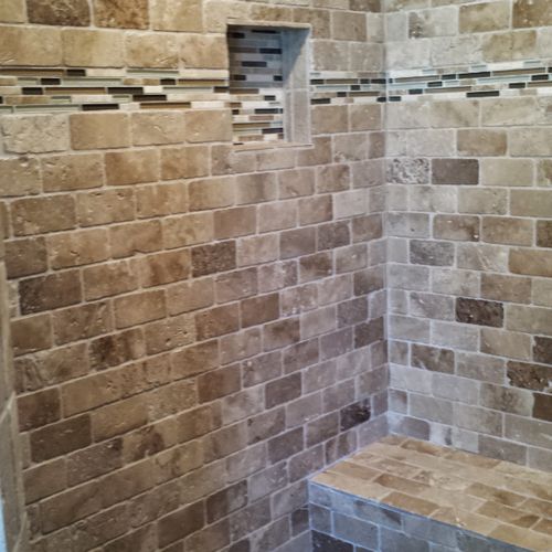 A look into the shower. tumbled marble in a brick 