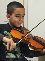 young violin student Jason B. concentrates during 