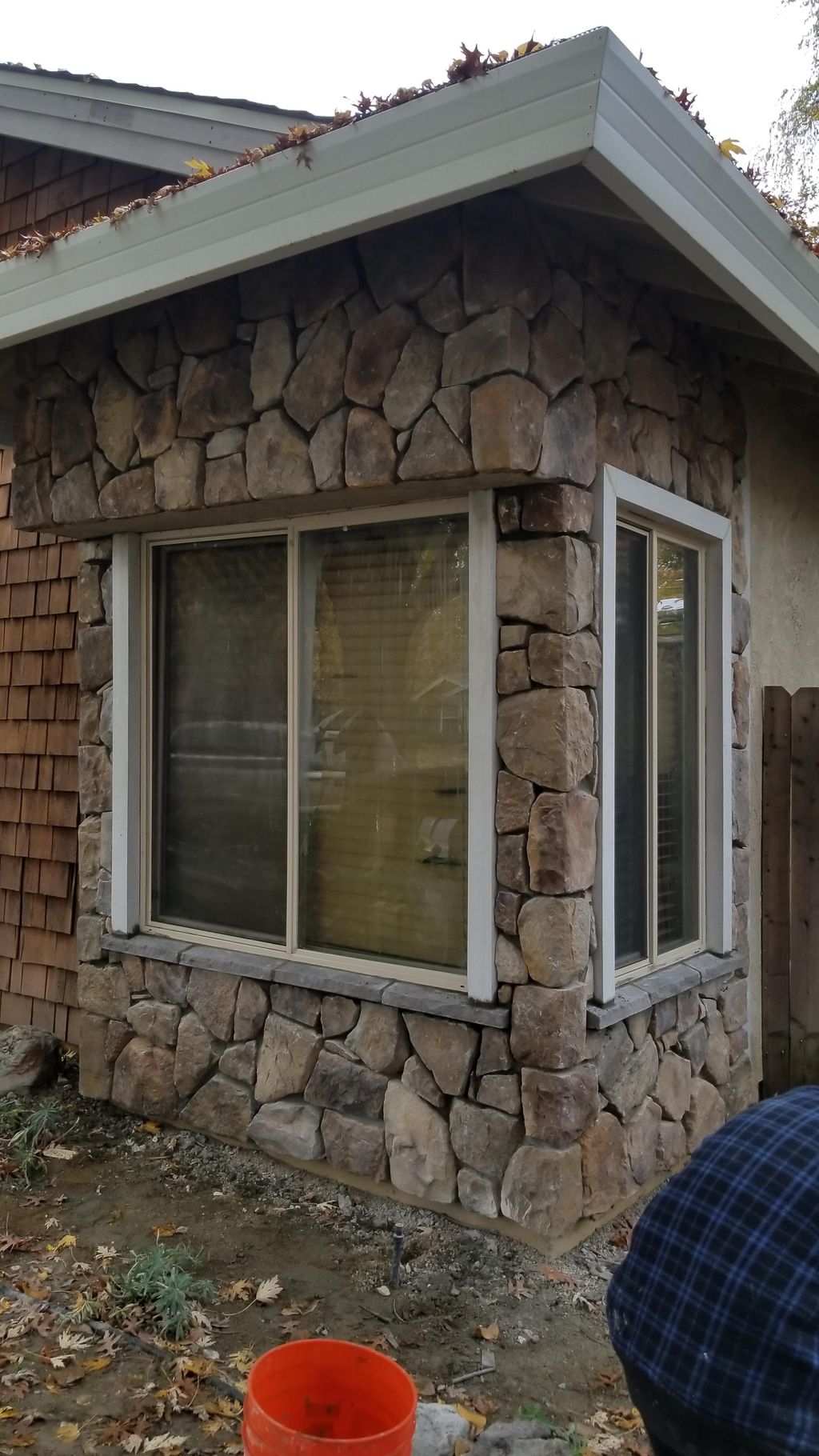 Giving this house a new look with stone and stucco