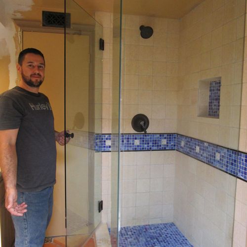 Clear shower enclosure shows off new tile.