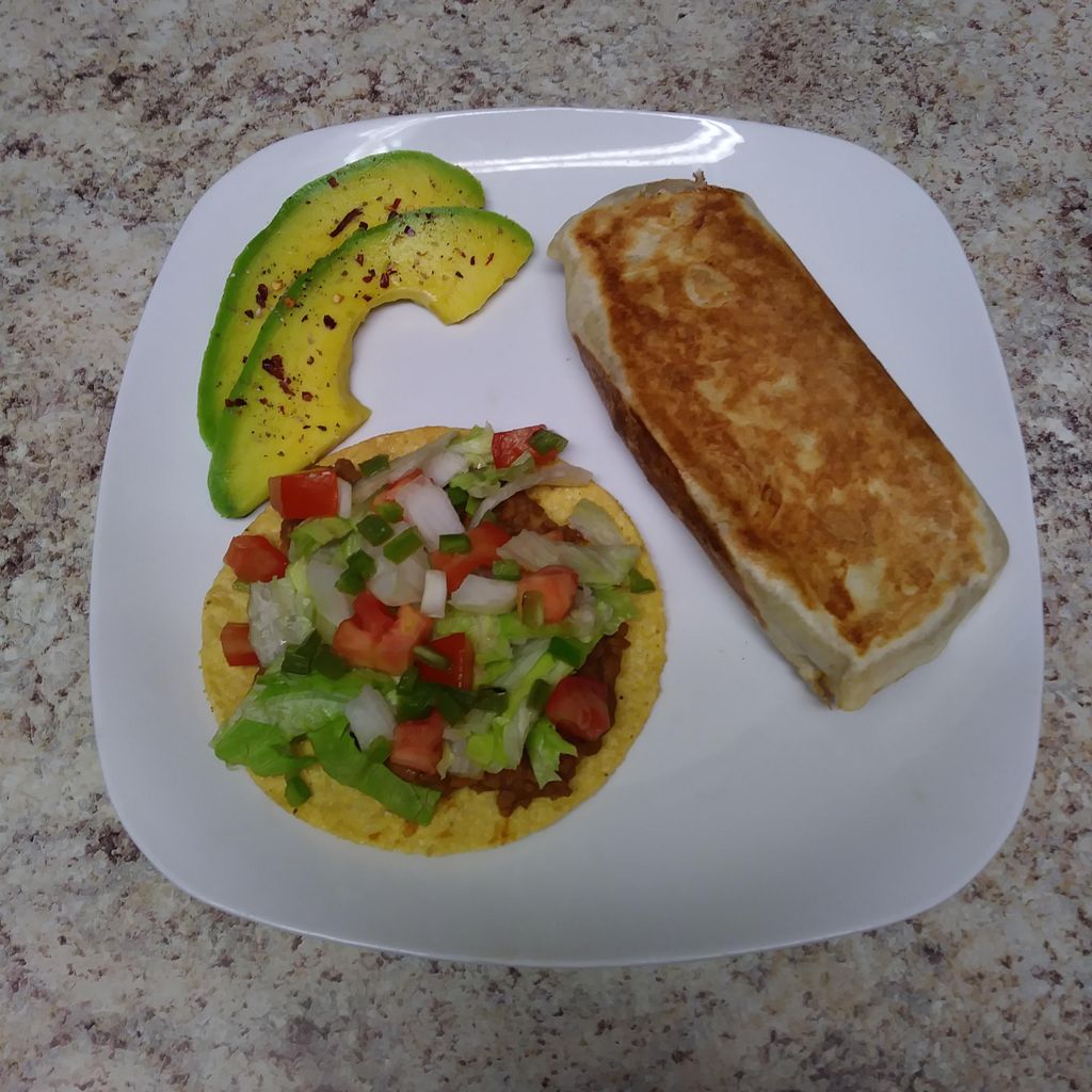 Vegan beef, bean, and rice burrito with a bean tos