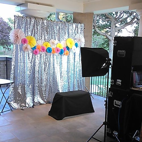 Elegant sequin backdrop decorated with paper fans.