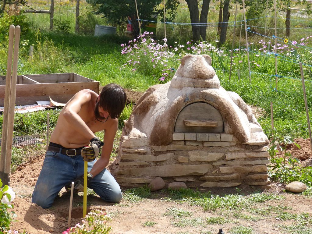Working on the foundation of the cob oven shelter.