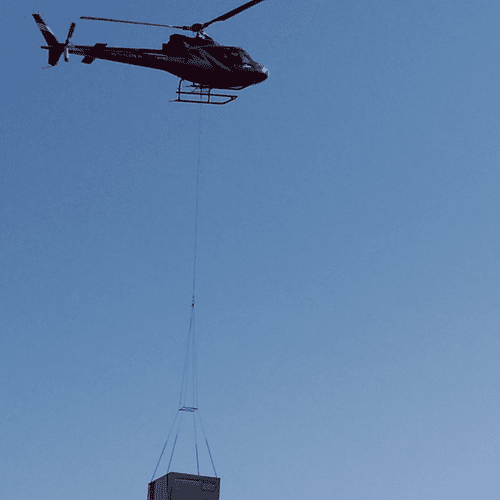 Helicopter delivering a 20 Ton Rooftop Unit