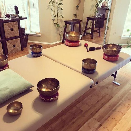 Singing bowls placed on treatment table, creating 