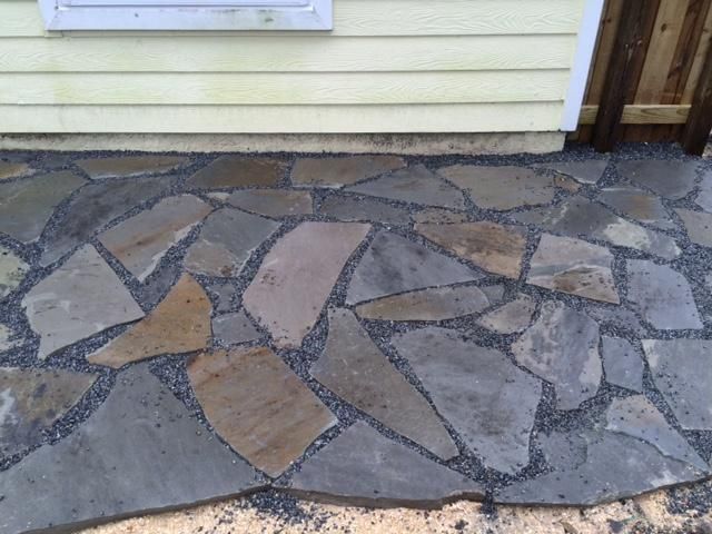 A close up view of a natural stone patio.  Our cli