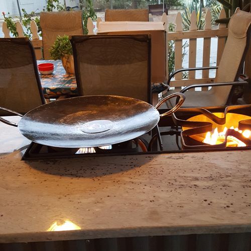 Wok hand-made from a tractor disc and horseshoes. 