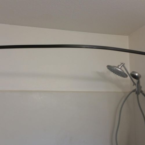 Floating extended shower rod for more room and loo