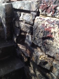 Before photos of a deteriorated basement entry bui