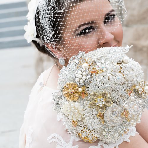A silver brooch bouquet, with gold highlights.